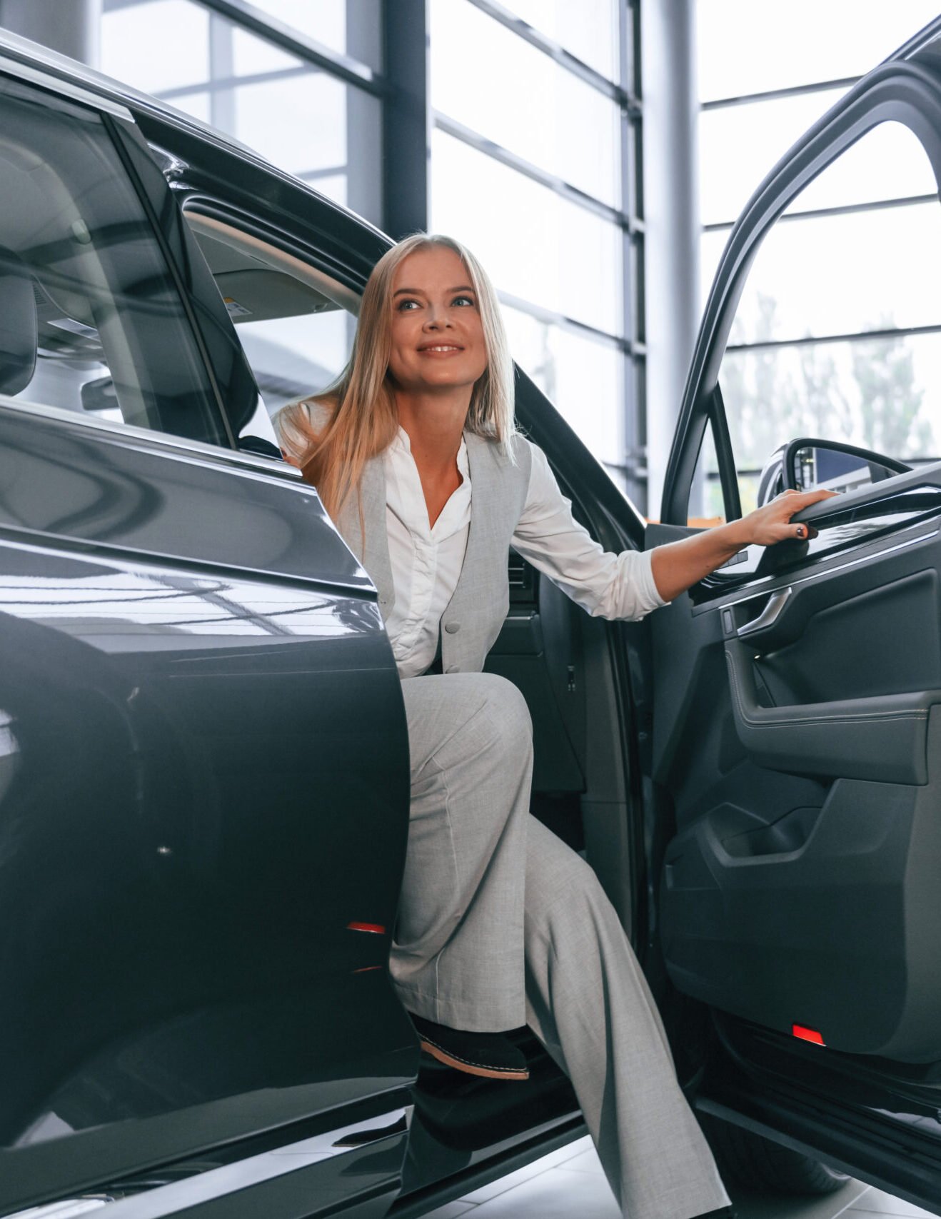 woman is walking out of a modern car